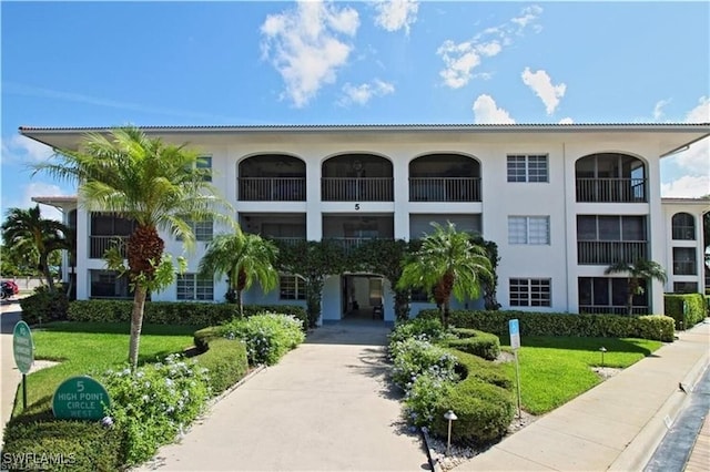 view of building exterior with concrete driveway