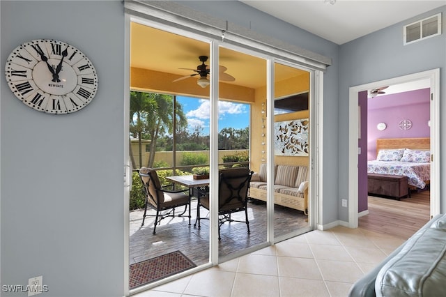 doorway to outside with light tile patterned floors and ceiling fan