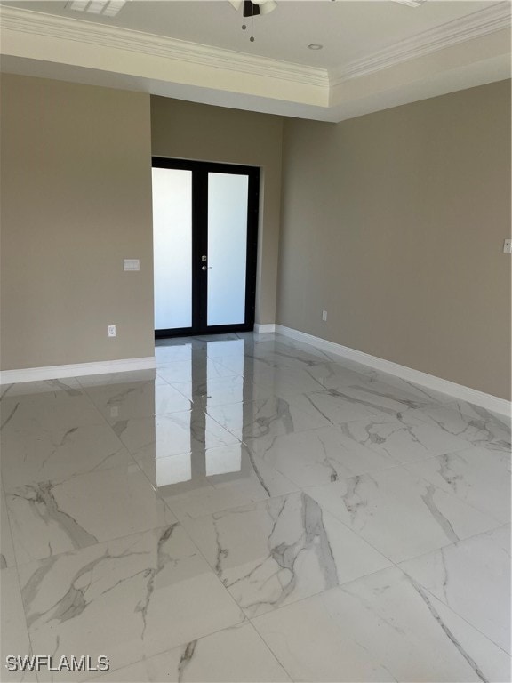 unfurnished room featuring french doors, a tray ceiling, and crown molding