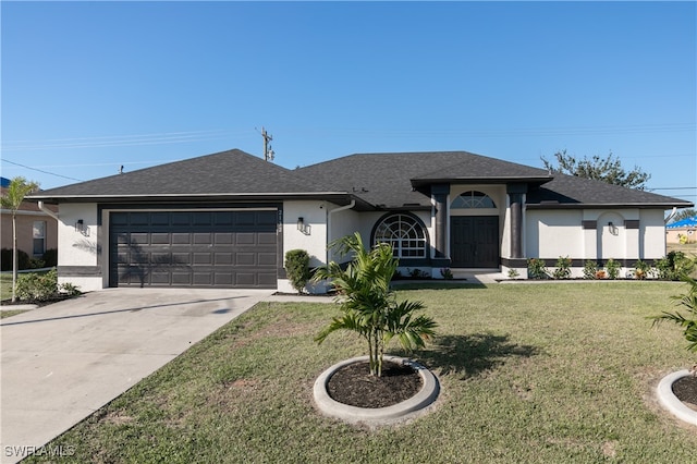 view of front of house with a front yard and a garage