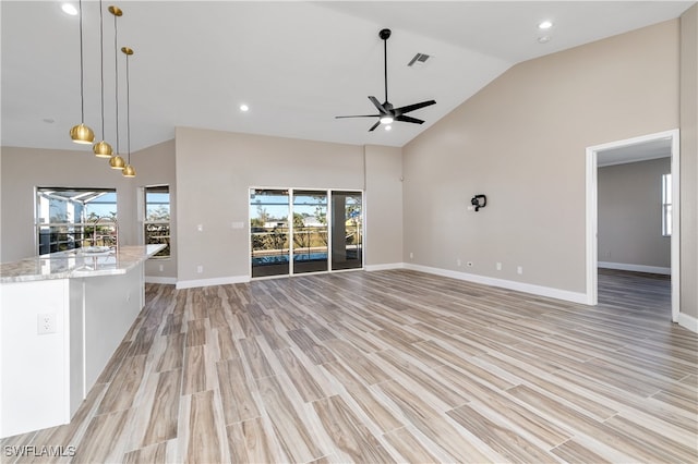 unfurnished living room featuring light hardwood / wood-style flooring, high vaulted ceiling, and ceiling fan