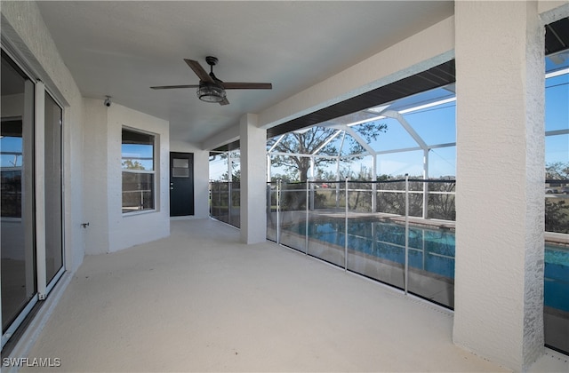 view of patio / terrace with ceiling fan, a fenced in pool, and a lanai