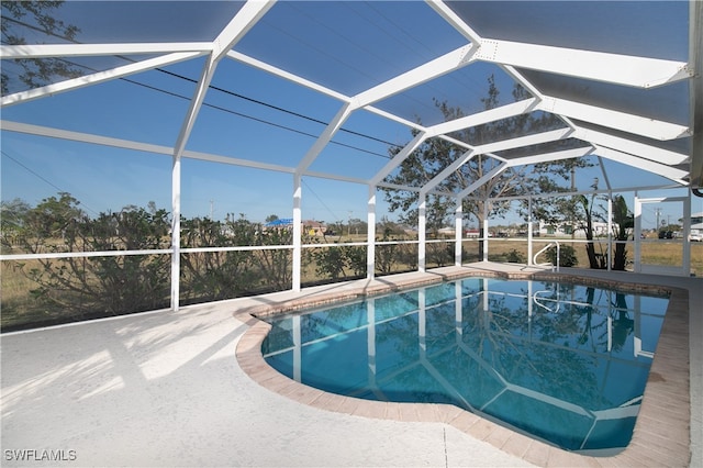 view of swimming pool featuring a patio area and glass enclosure