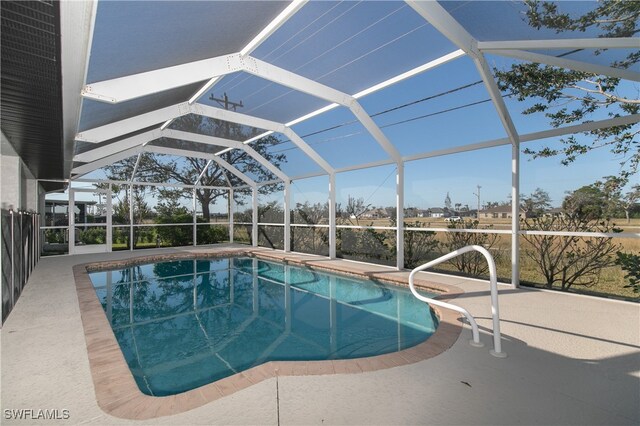 view of swimming pool with a patio and glass enclosure