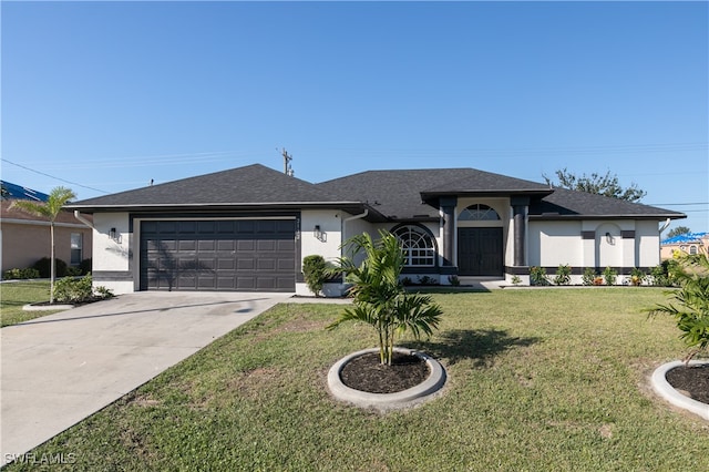 view of front of home featuring a garage and a front lawn