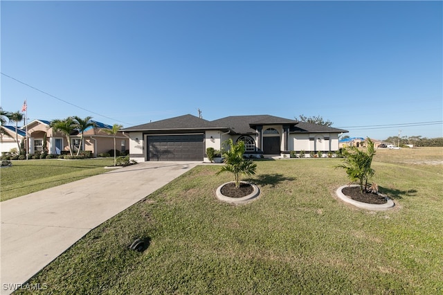 view of front of house with a garage and a front lawn