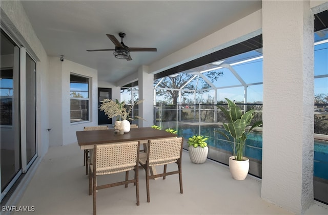 sunroom / solarium featuring ceiling fan