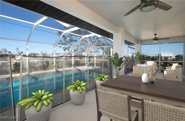 exterior space featuring glass enclosure and ceiling fan