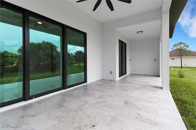 view of patio featuring ceiling fan