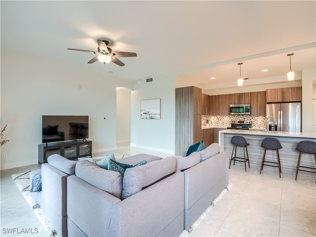 tiled living room featuring ceiling fan