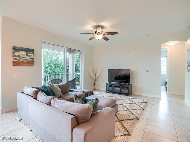 living room featuring ceiling fan and light tile patterned flooring