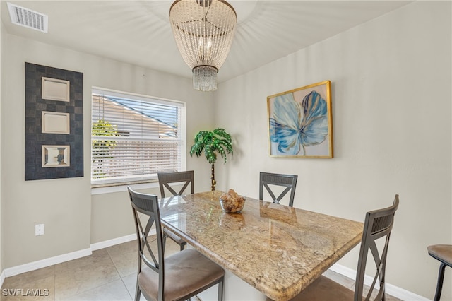 dining room with an inviting chandelier and light tile patterned flooring