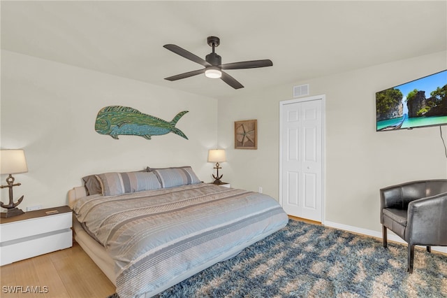 bedroom with ceiling fan and hardwood / wood-style flooring