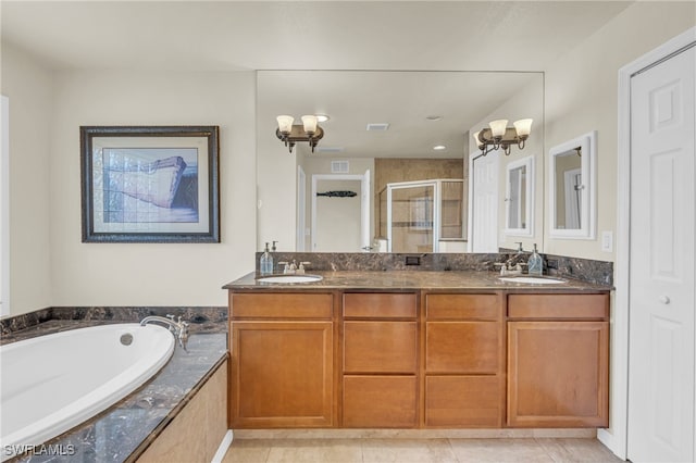 bathroom featuring independent shower and bath, vanity, and tile patterned flooring