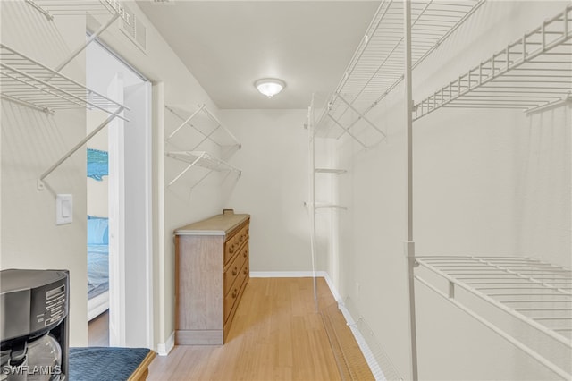 spacious closet with hardwood / wood-style floors