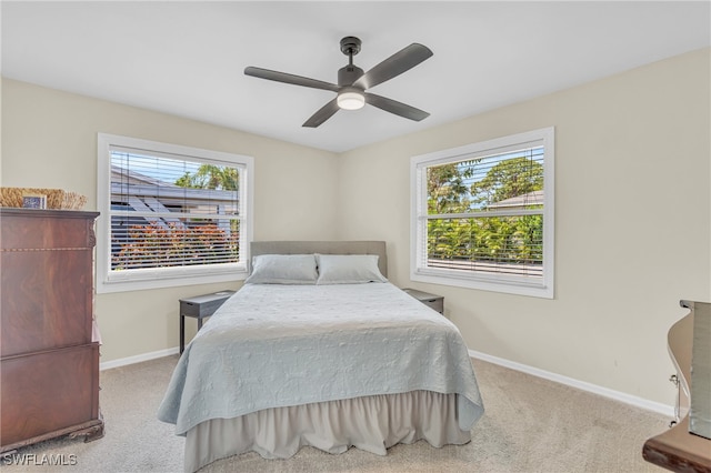 bedroom featuring light carpet and ceiling fan