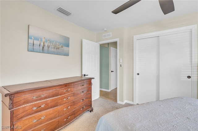 bedroom featuring light carpet, a closet, and ceiling fan