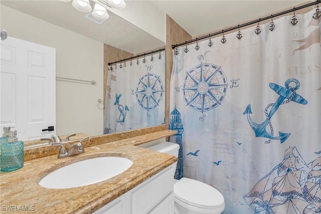 bathroom featuring vanity, toilet, and a shower with shower curtain