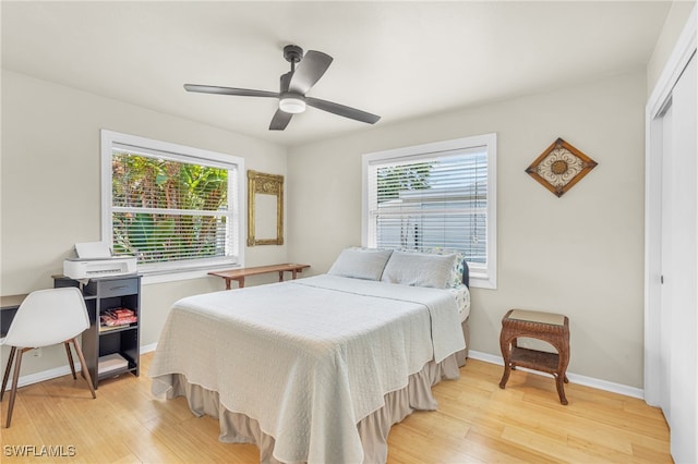 bedroom featuring ceiling fan, a closet, and light hardwood / wood-style floors