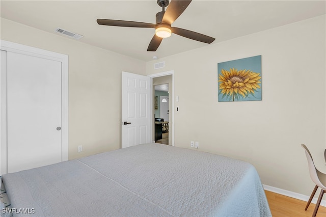 bedroom featuring ceiling fan, a closet, and light hardwood / wood-style floors