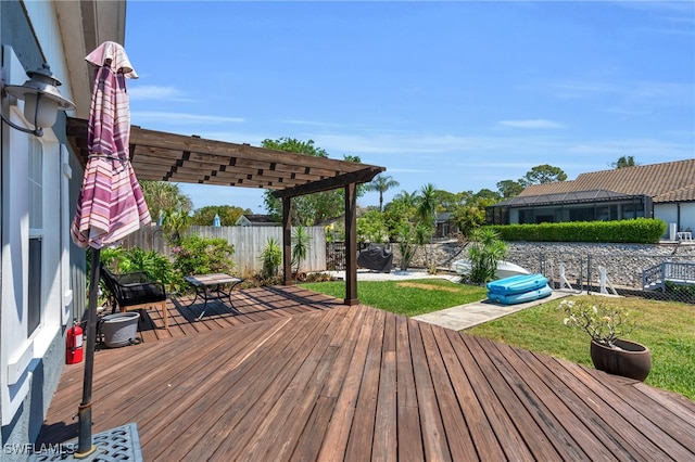 deck with a pergola and a yard