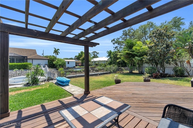 wooden terrace featuring a yard and a pergola