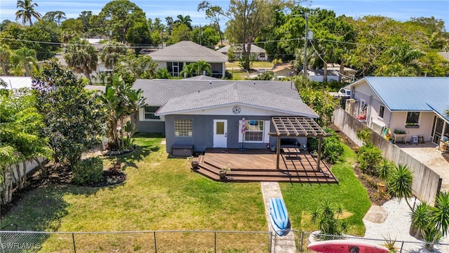 rear view of house featuring a wooden deck, a gazebo, and a yard