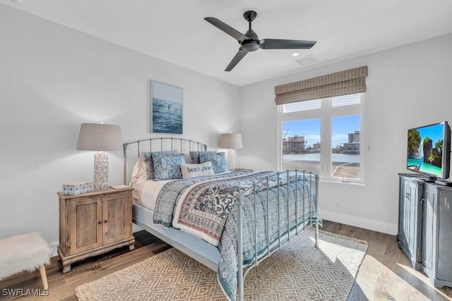 bedroom with ceiling fan and light wood-type flooring