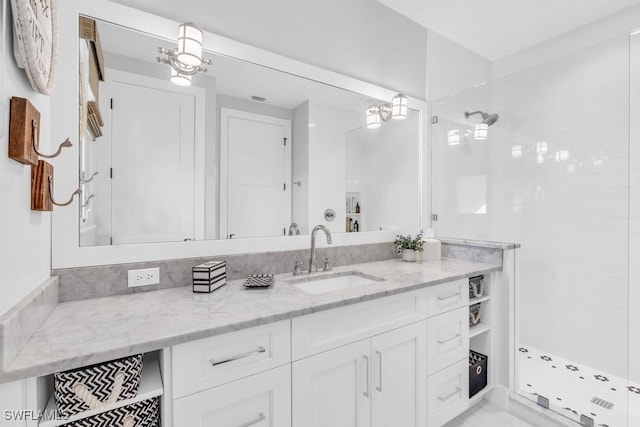 bathroom featuring vanity and a shower