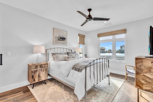 bedroom with ceiling fan and hardwood / wood-style floors