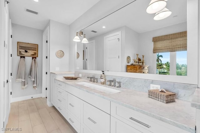 bathroom featuring wood-type flooring and vanity