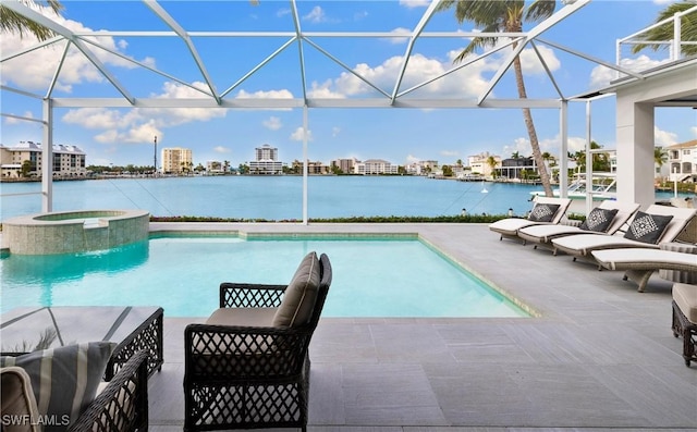 view of pool featuring glass enclosure, a water view, an in ground hot tub, and a patio