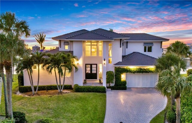 view of front of house with a yard and a garage