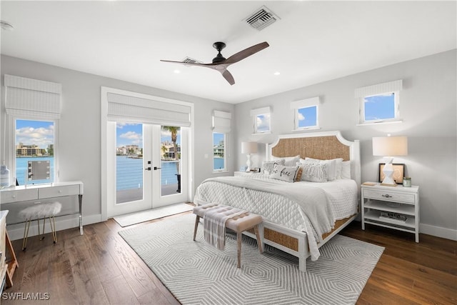 bedroom featuring ceiling fan, access to exterior, a water view, and french doors