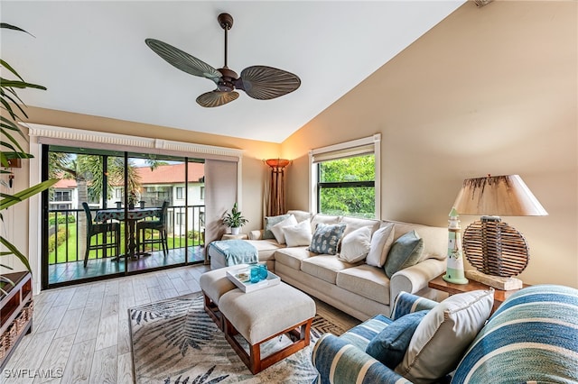 living room with ceiling fan, light wood-type flooring, and high vaulted ceiling