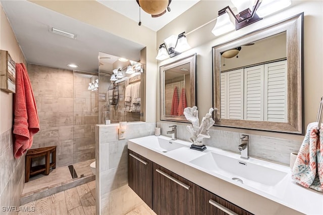 bathroom featuring a walk in shower, double vanity, toilet, and recessed lighting