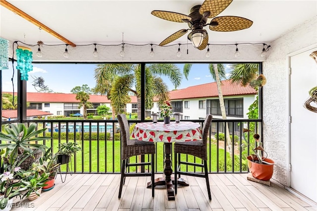 wooden deck featuring ceiling fan and a lawn