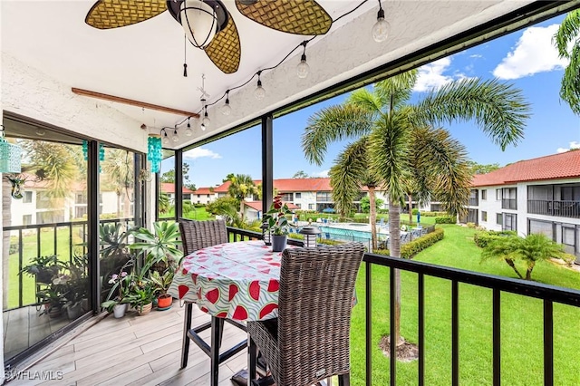 sunroom with outdoor dining space and plenty of natural light