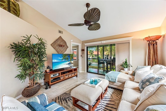 living room featuring vaulted ceiling, wood finished floors, ceiling fan, and baseboards