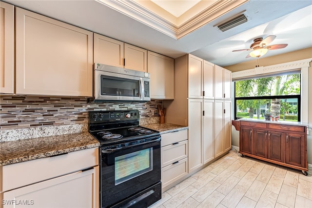 kitchen featuring ceiling fan, dark stone counters, backsplash, and electric range