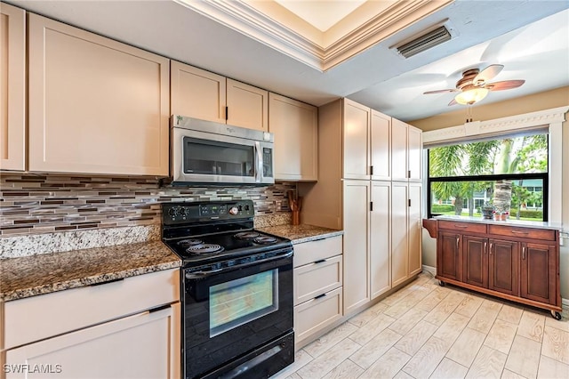 kitchen with stainless steel microwave, black electric range, tasteful backsplash, dark stone counters, and ceiling fan