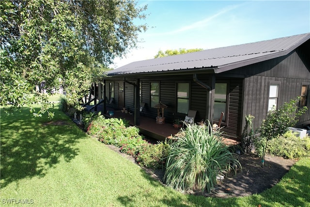 rear view of property featuring a yard