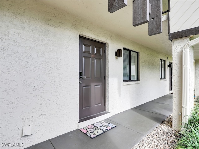 property entrance featuring stucco siding