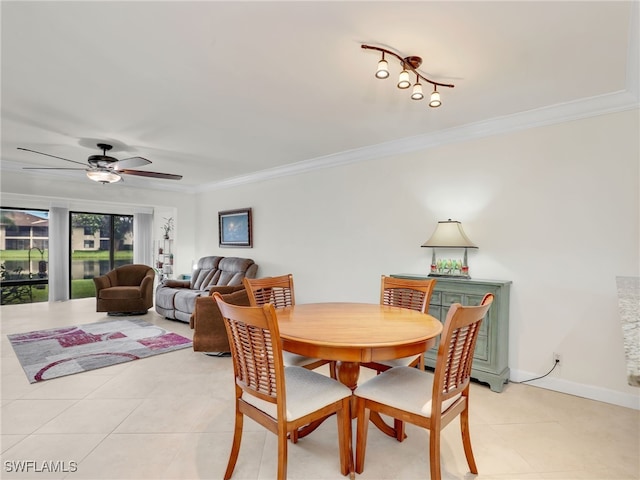 dining space with light tile patterned floors, baseboards, ceiling fan, and ornamental molding