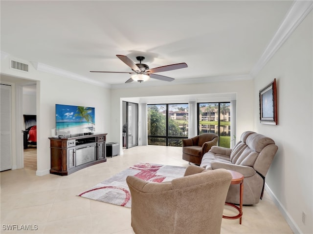 living room featuring visible vents, ceiling fan, baseboards, ornamental molding, and light tile patterned floors