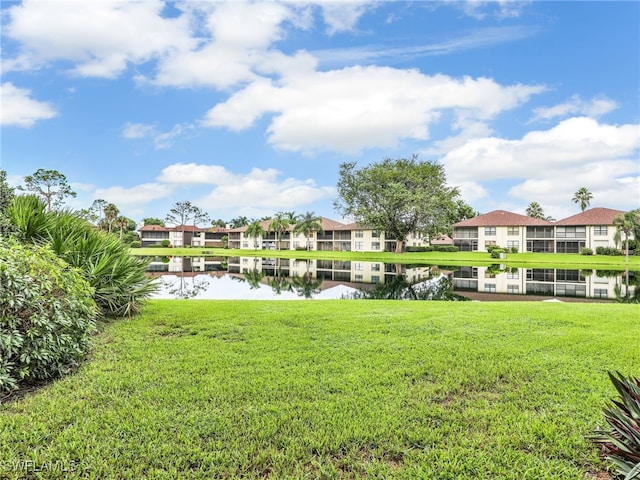 view of yard featuring a water view and a residential view