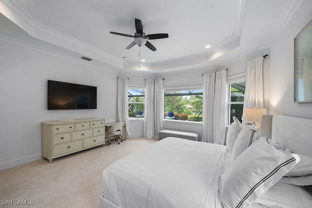 bedroom with light colored carpet, ceiling fan, a raised ceiling, and crown molding