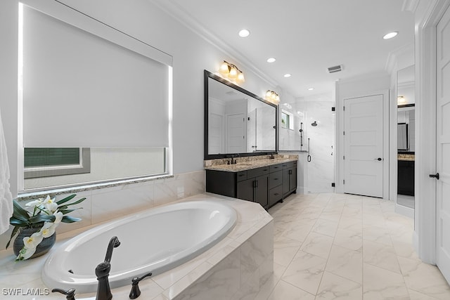 bathroom featuring crown molding, vanity, and separate shower and tub