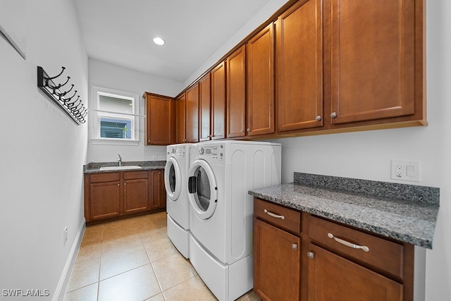 laundry area with separate washer and dryer, cabinets, sink, and light tile patterned flooring