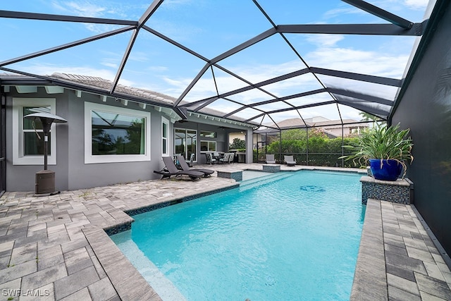 view of swimming pool with a lanai and a patio area